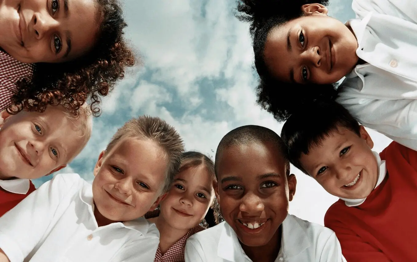 image-1 Smiling children looking down at camera.